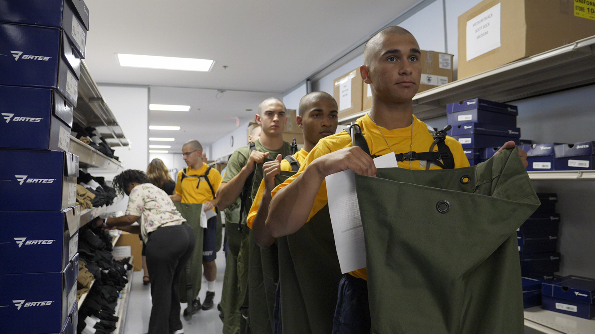 Soldiers selecting clothing from shelves