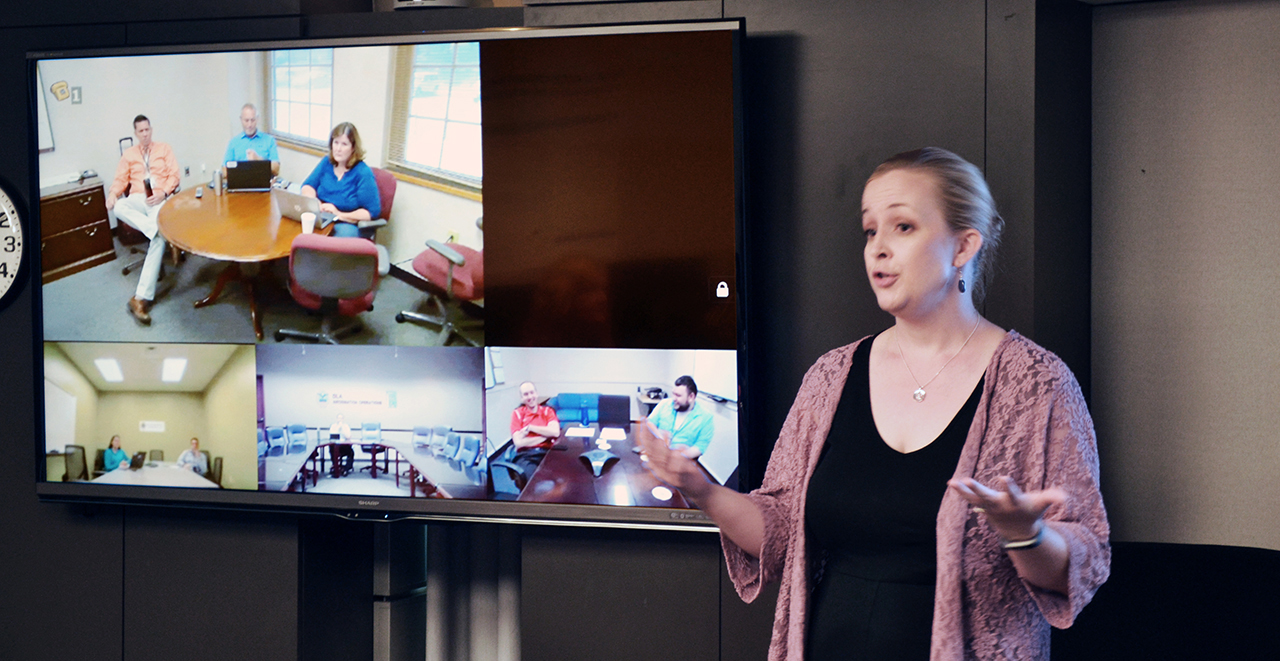 Image of woman talking in front of a video conference screen