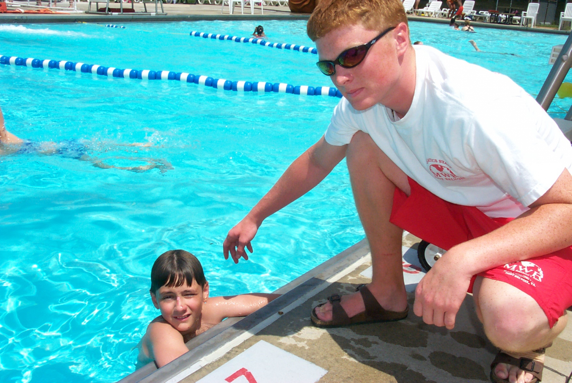 boy in pool with lifeguard