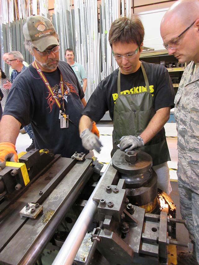 men looking at aircraft part