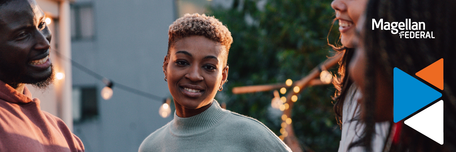 African American woman surrounded by friends at an outdoor event.