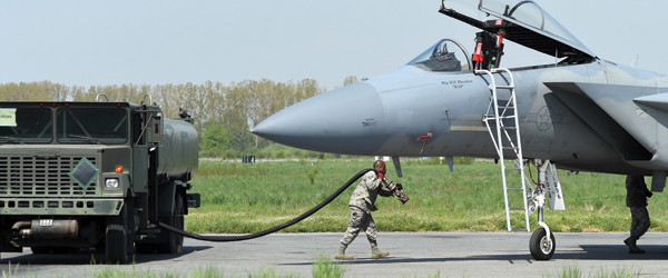 A military airplane refuels on the flight line