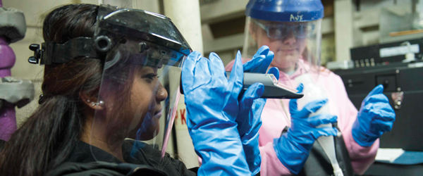 Interns examine a fuel sample in a fuel lab