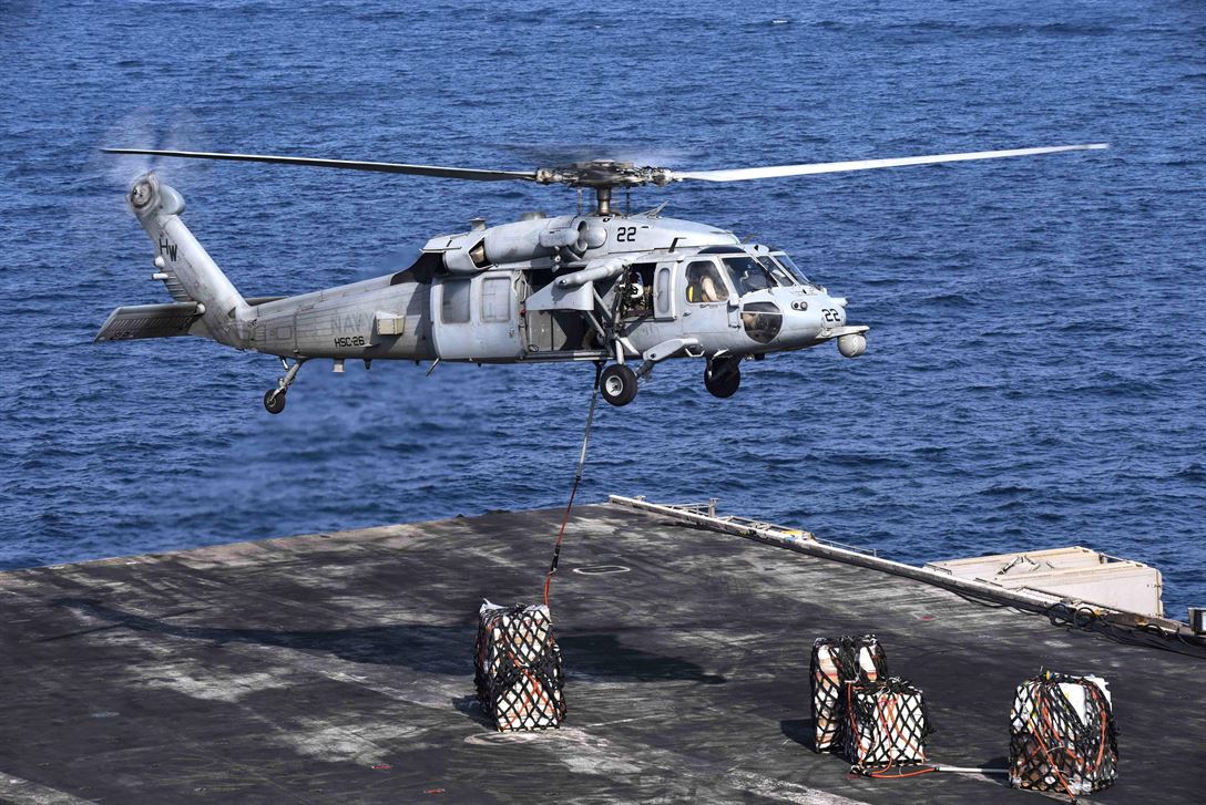 A helicopter landing on a ship