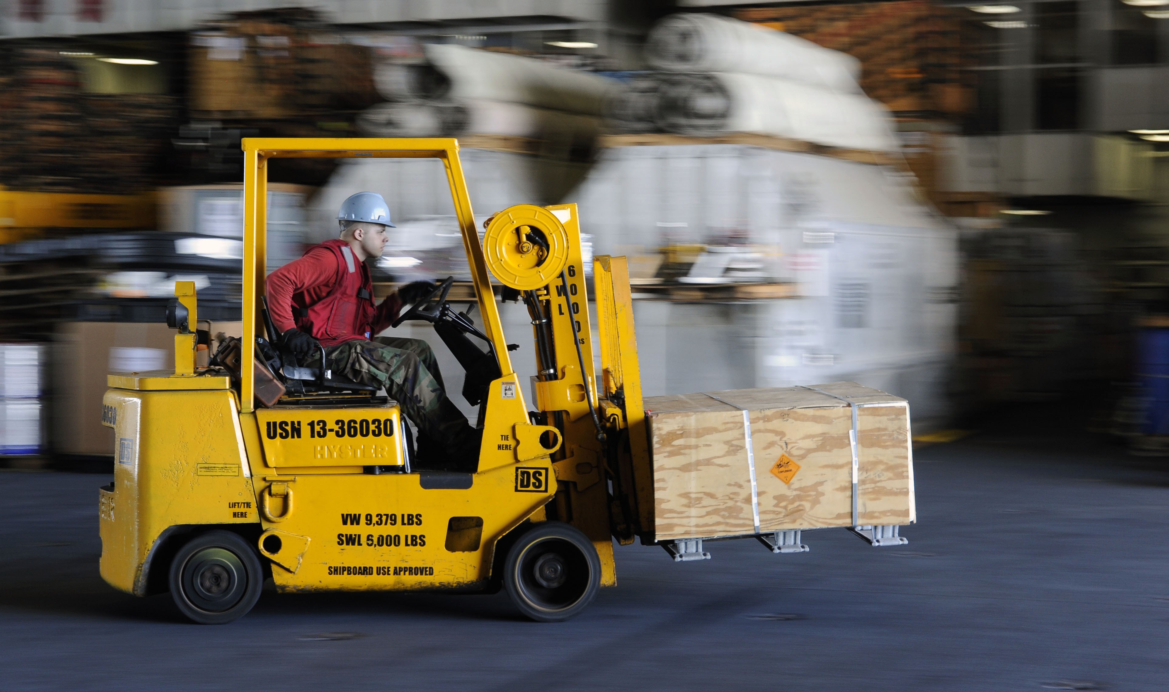 A forklift moves through a warehouse