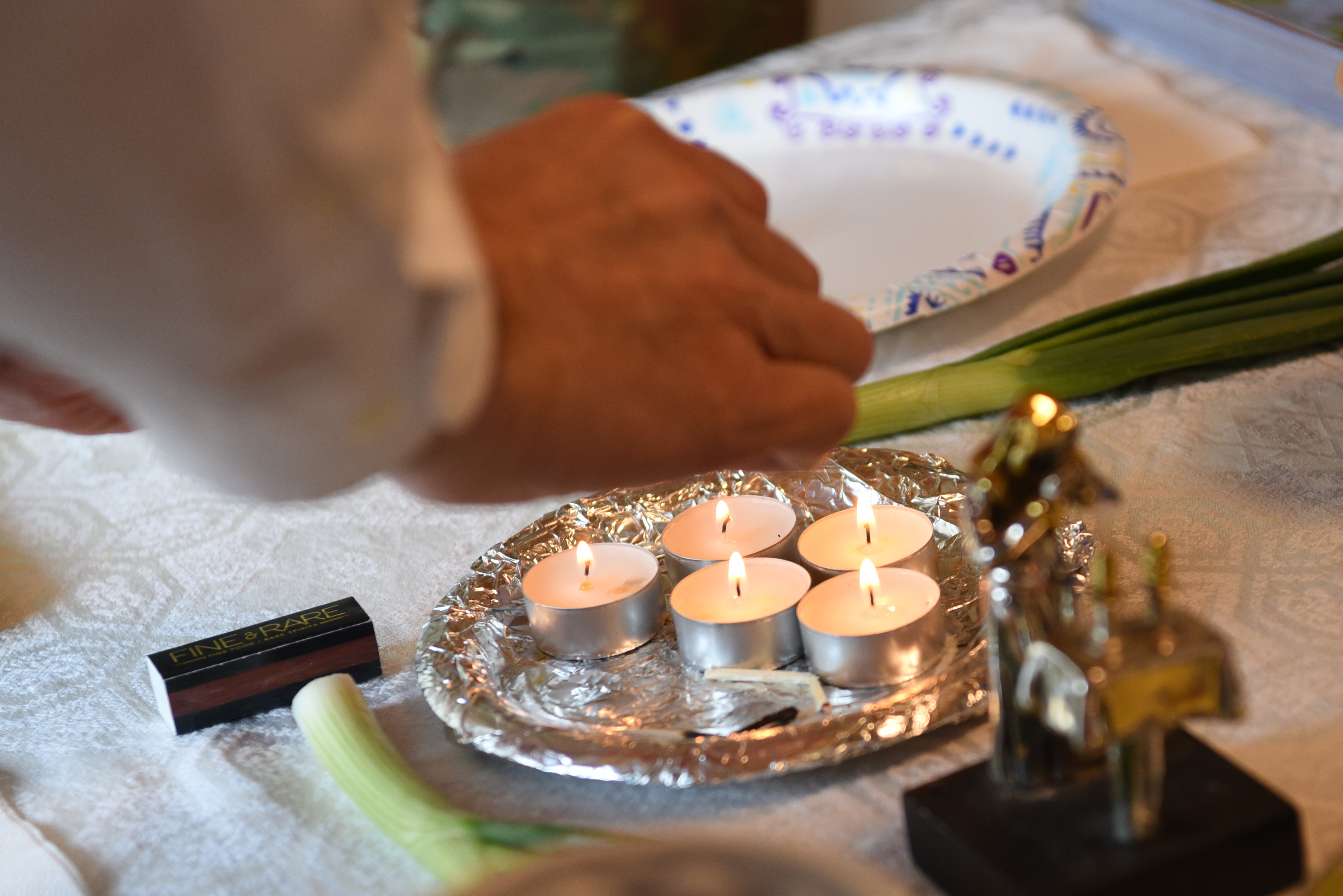 Small candles being lit on a table