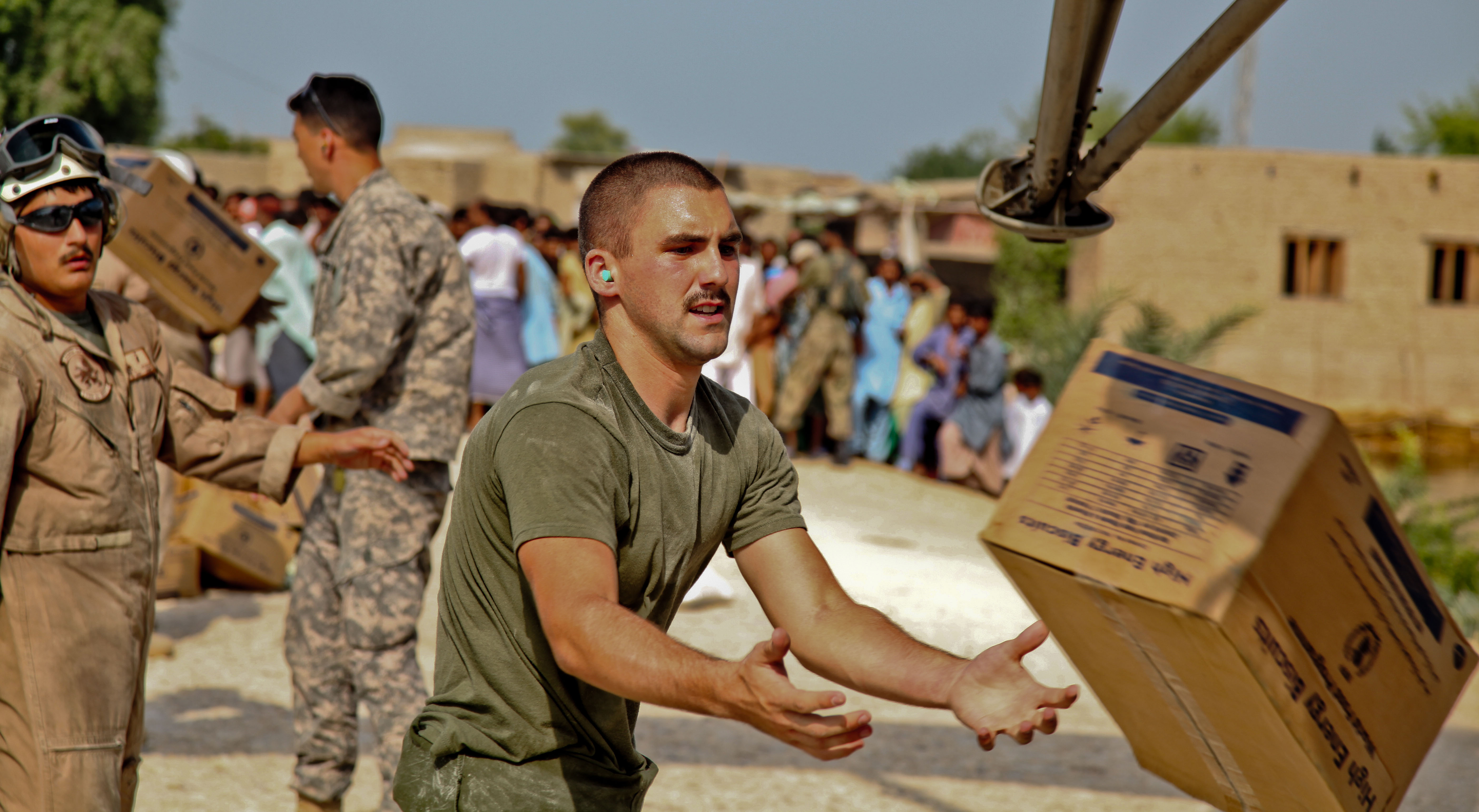 DLA troop support personnel distributing supplies to locals